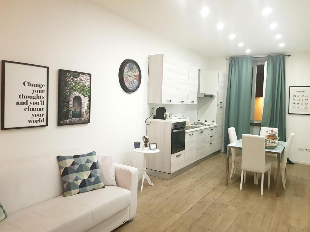 a living room and kitchen with a couch and a table at APARTMENT VITERBO CENTRO CORSO in Viterbo