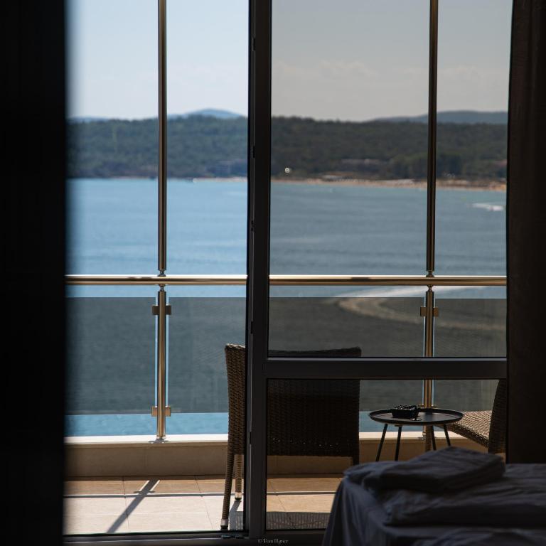 a room with a view of the water through a window at Solinaria Boutique Hotel in Sozopol
