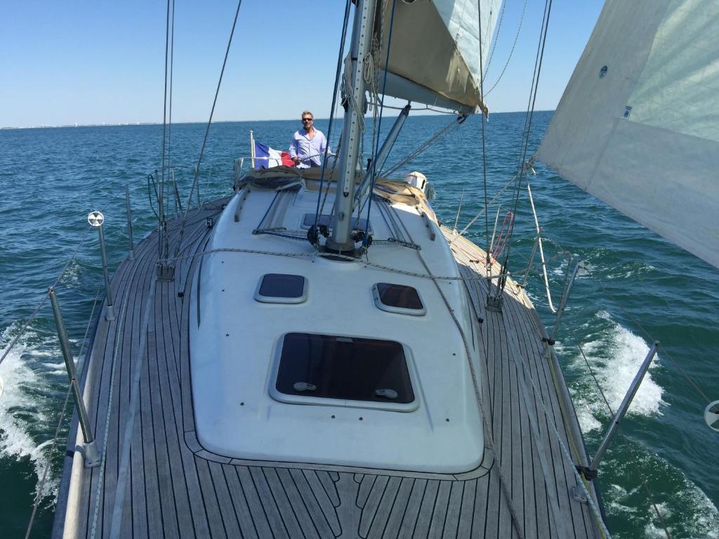 a man sitting on the top of a boat in the water at VOILIER ESTEREL in La Rochelle