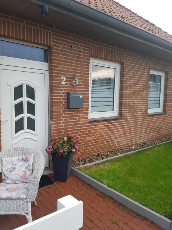 uma casa de tijolos com uma porta branca e uma cadeira em Romantiksuite only two em Sarstedt