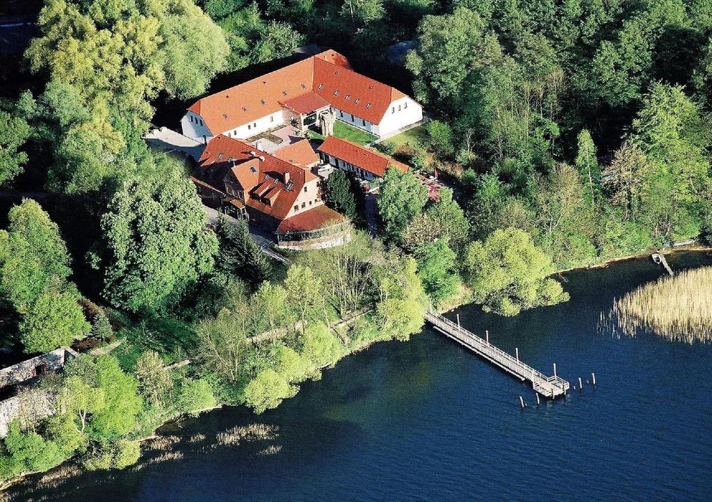 an aerial view of a house on an island in the water at Seehotel Heidehof in Klein Nemerow