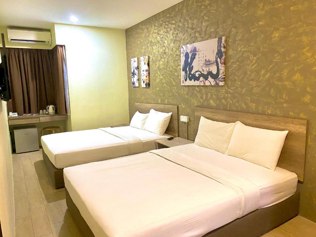 Ein Bett oder Betten in einem Zimmer der Unterkunft SH Hotel Kota Damansara