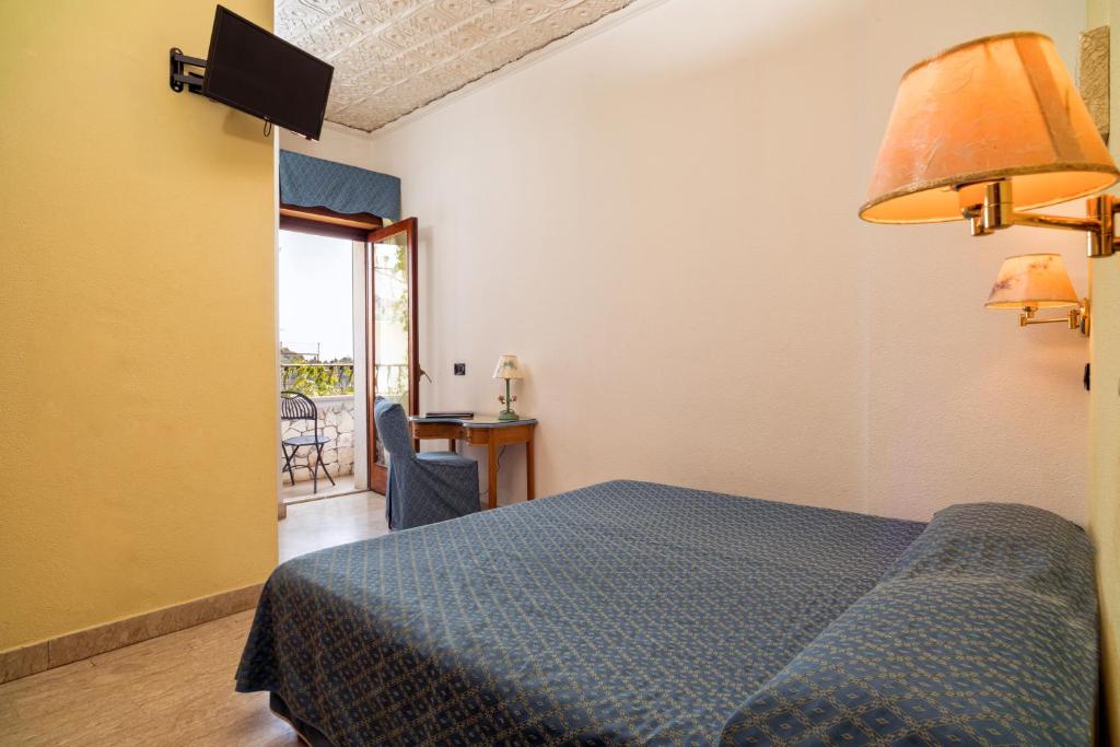 Postel nebo postele na pokoji v ubytování Hotel Vello d'Oro