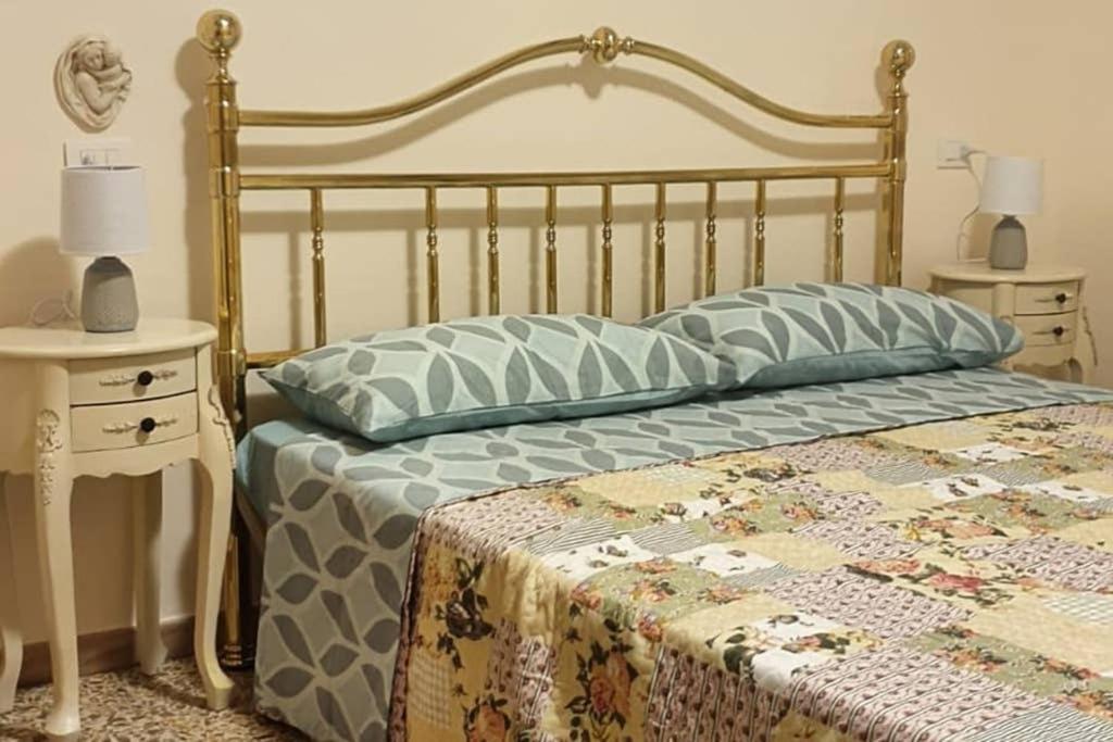 a bedroom with a bed with a quilt on it at Appartamento La Cupola in Santa Maria degli Angeli