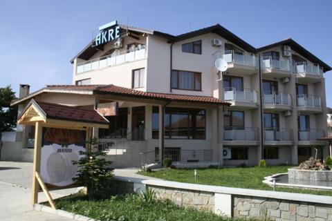 a large building with a sign in front of it at Hotel Akre in Kavarna