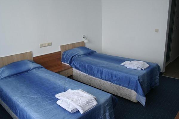 two beds in a hotel room with towels on them at Hotel Akre in Kavarna