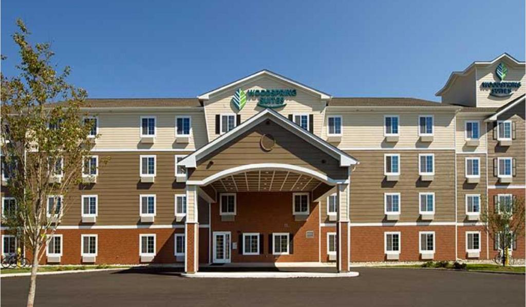a large apartment building with an archway in front of it at WoodSpring Suites Allentown in Allentown