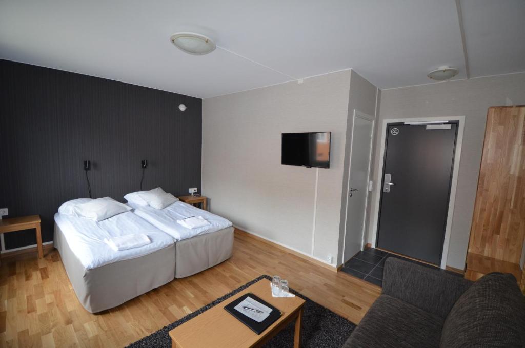Postel nebo postele na pokoji v ubytování Hotell Svanen