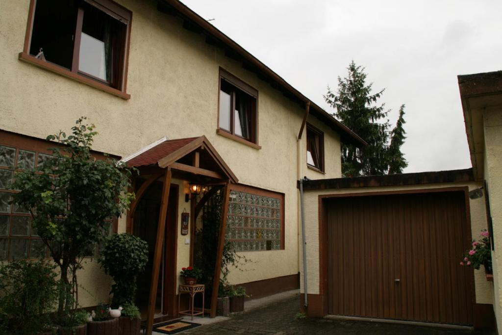 a house with a garage and a building at Ferienhaus Susanne in Haßloch