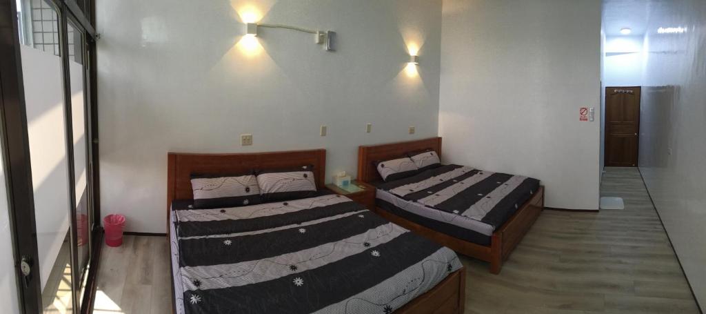 Postel nebo postele na pokoji v ubytování 瑞恒行館Reui Heng Guesthouse