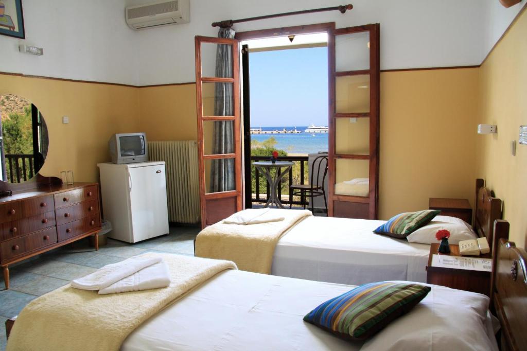Postel nebo postele na pokoji v ubytování Hotel Boulis