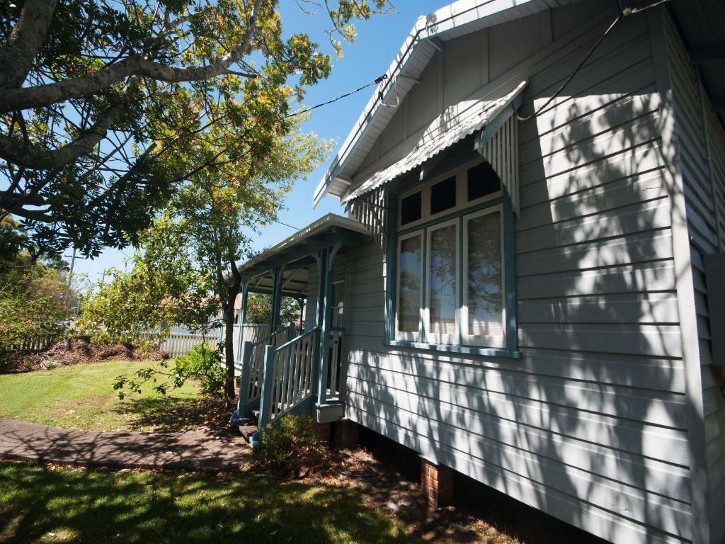 a small house with a porch on the side of it at Where the River Runs in Tea Gardens