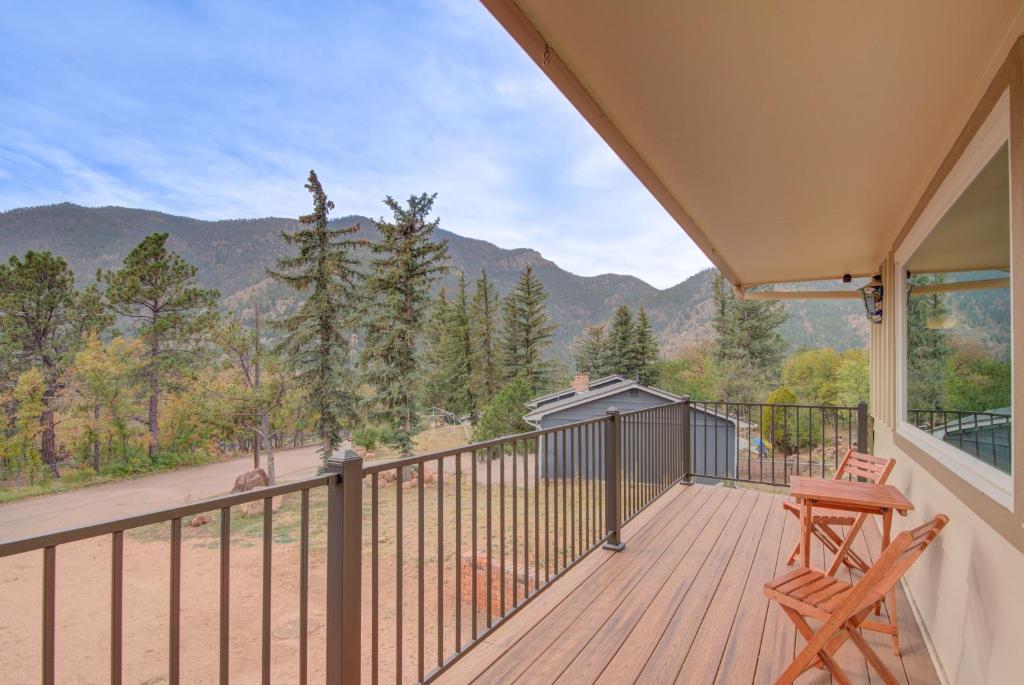 a balcony with a table and two chairs on a deck at *Home Away From Home Cabin in the Mountains* in Cascade-Chipita Park