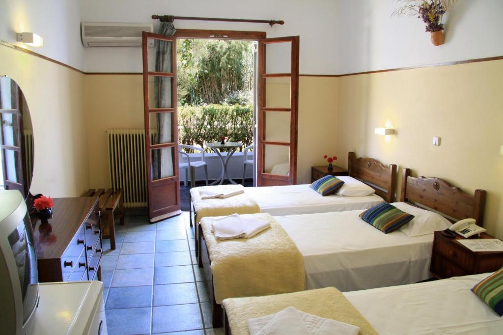 Postel nebo postele na pokoji v ubytování Hotel Boulis