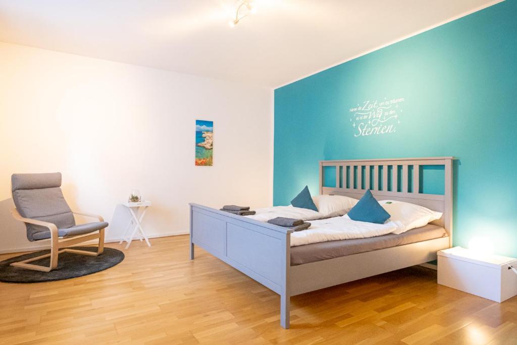 a bedroom with a bed and a chair in it at Ferienwohnung zum Wohlfühlen in Essen