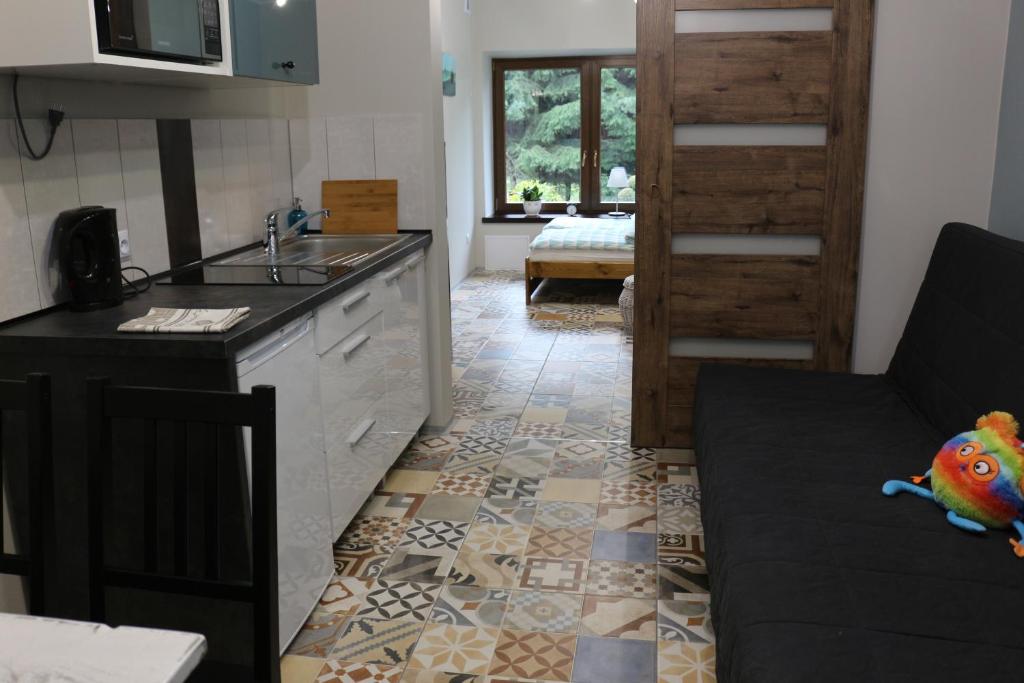 a kitchen with a sink and a counter top at Apartament Leszczynowa 7 blisko Zatora in Spytkowice