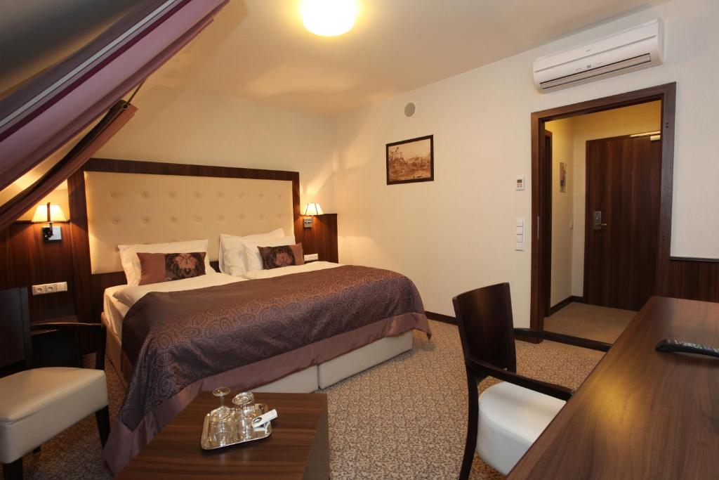 Postel nebo postele na pokoji v ubytování Hotel Sladovna