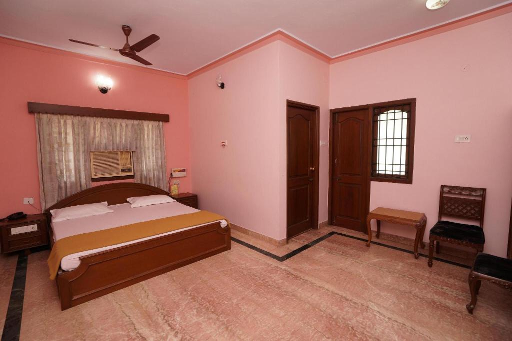 a bedroom with a bed and a ceiling fan at Lloyds Serviced Apartments,Krishna Street,T Nagar in Chennai
