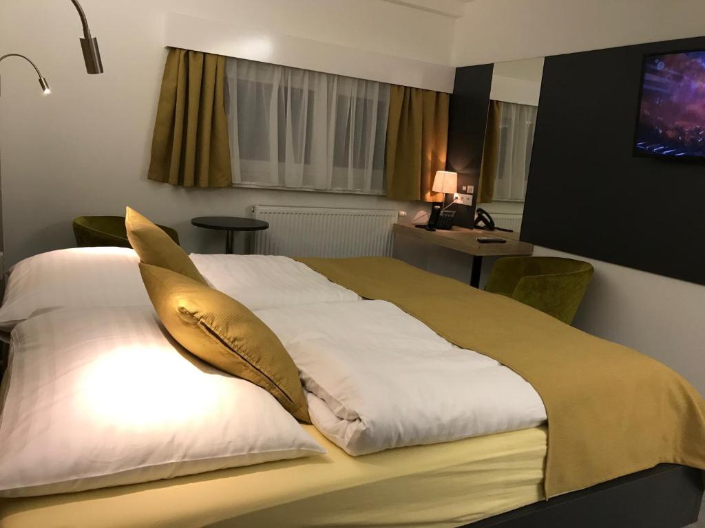 A bed or beds in a room at Primma Hotel