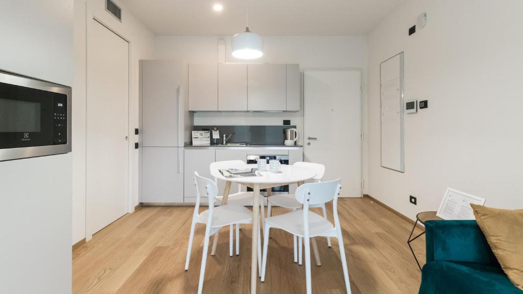 a kitchen and dining room with a white table and chairs at Italianway - Lazzaro Papi 14 A in Milan