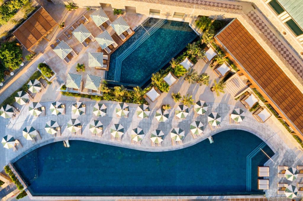 an overhead view of a pool at a resort at Daios Cove in Agios Nikolaos
