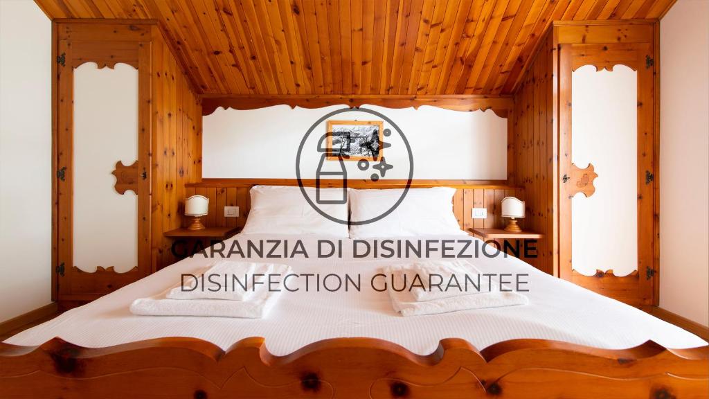 a bedroom with a bed with a wooden ceiling at Italianway - Besta 2 in Bormio