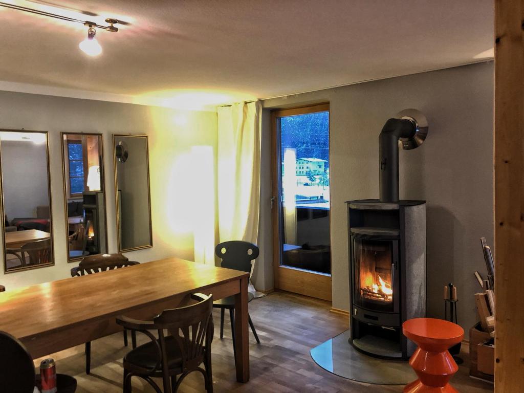 a living room with a table and a wood stove at Haus Albona in Klösterle