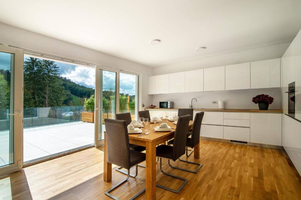 a kitchen and dining room with a table and chairs at Villa de Roya in Rogaška Slatina