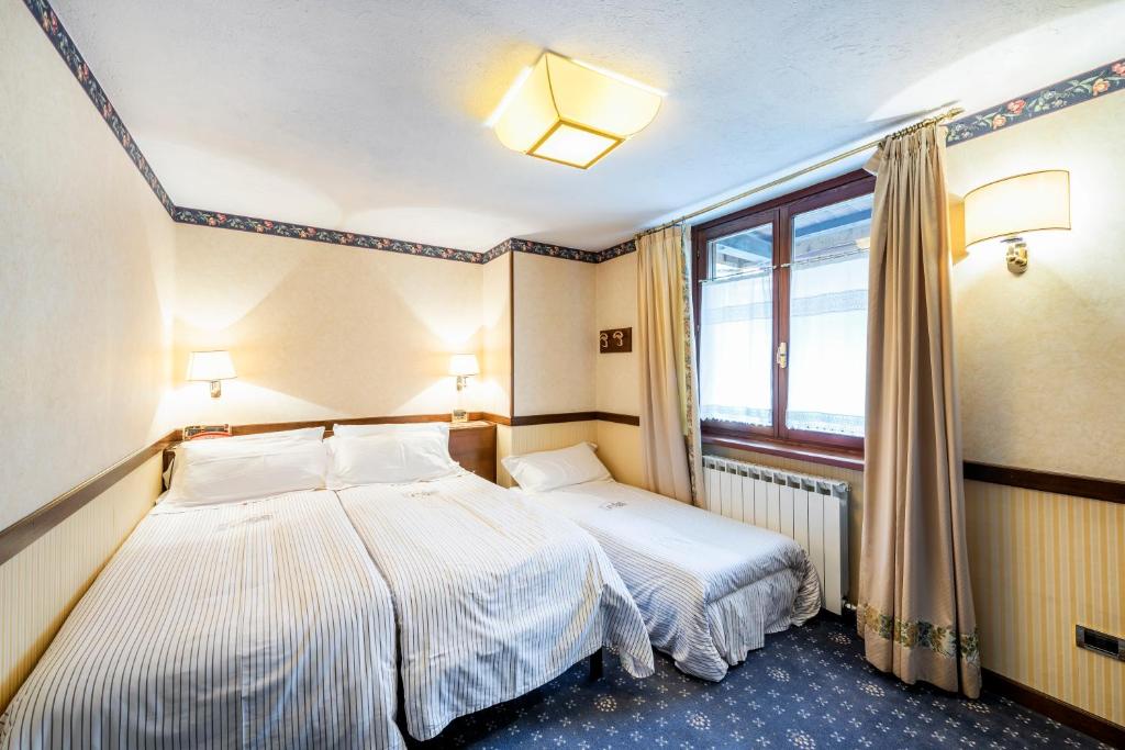 Postel nebo postele na pokoji v ubytování Hotel Petit Prince