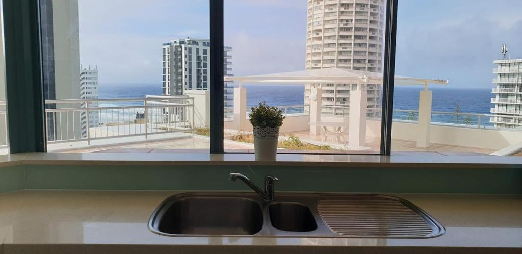 a sink in a kitchen with a view of the ocean at Crown Towers Resort Private Apartments in Gold Coast