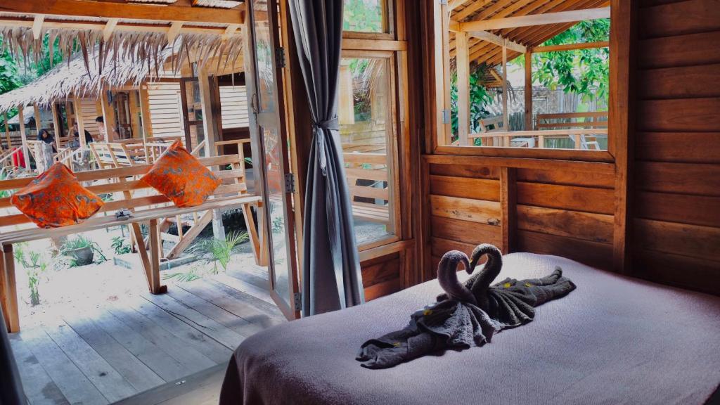 a room with a bed with two swans on it at The Hideaway, Koh Lipe in Ko Lipe
