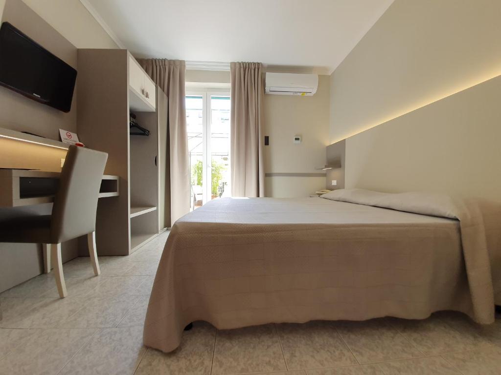 Postel nebo postele na pokoji v ubytování Hotel Corallo