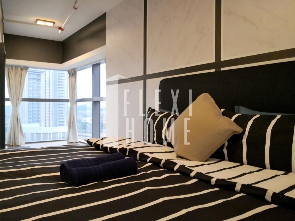 a room with a bed with black and white stripes at Pinnacle PJ, Romantic City View, 1-4 Guests Designed Duplex Home by Flexihome-MY in Petaling Jaya