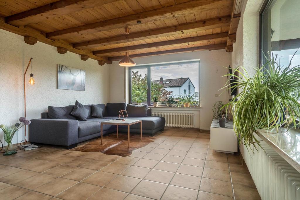 a living room with a couch and a table at Ferienwohnung im Haus Metzger in Oberteuringen