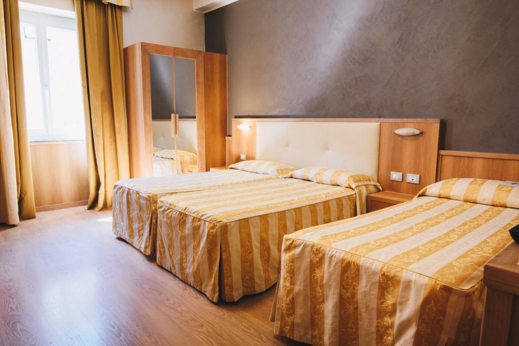 Postel nebo postele na pokoji v ubytování Hotel Corallo