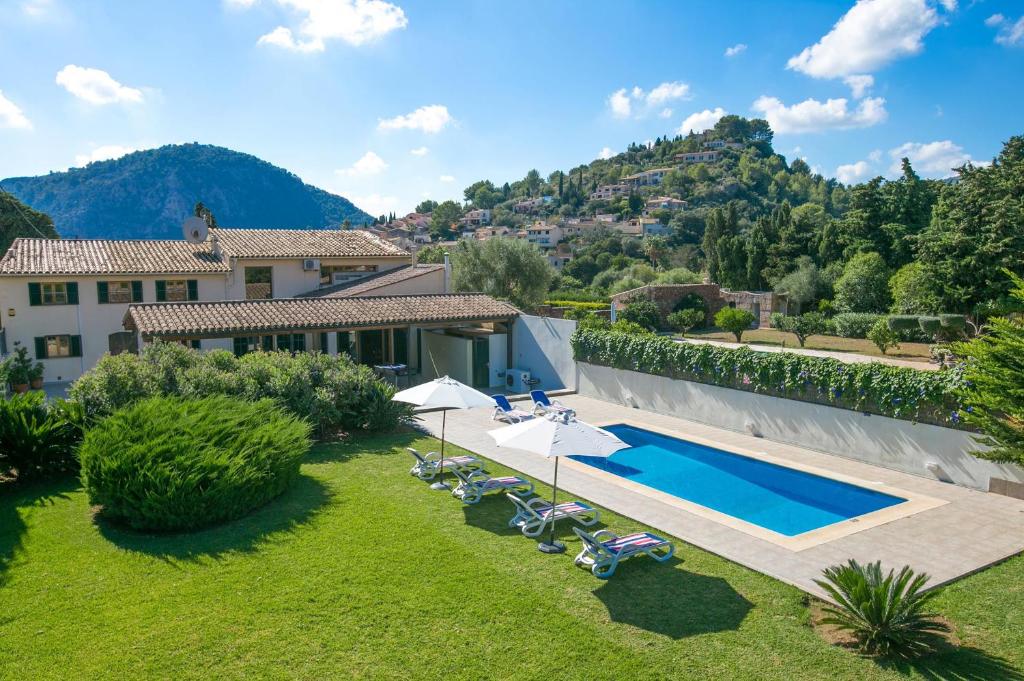an external view of a villa with a swimming pool at Villa LLOBINER in Pollença