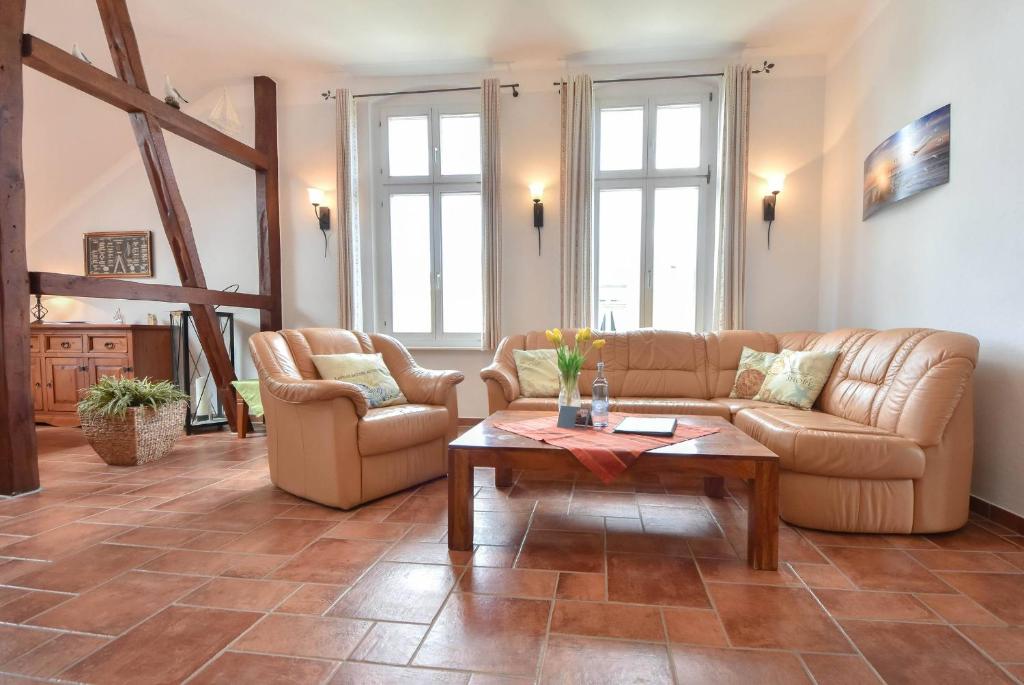 a living room with a couch and a table at Villa Elisabeth Wohnung Bernstein in Heringsdorf