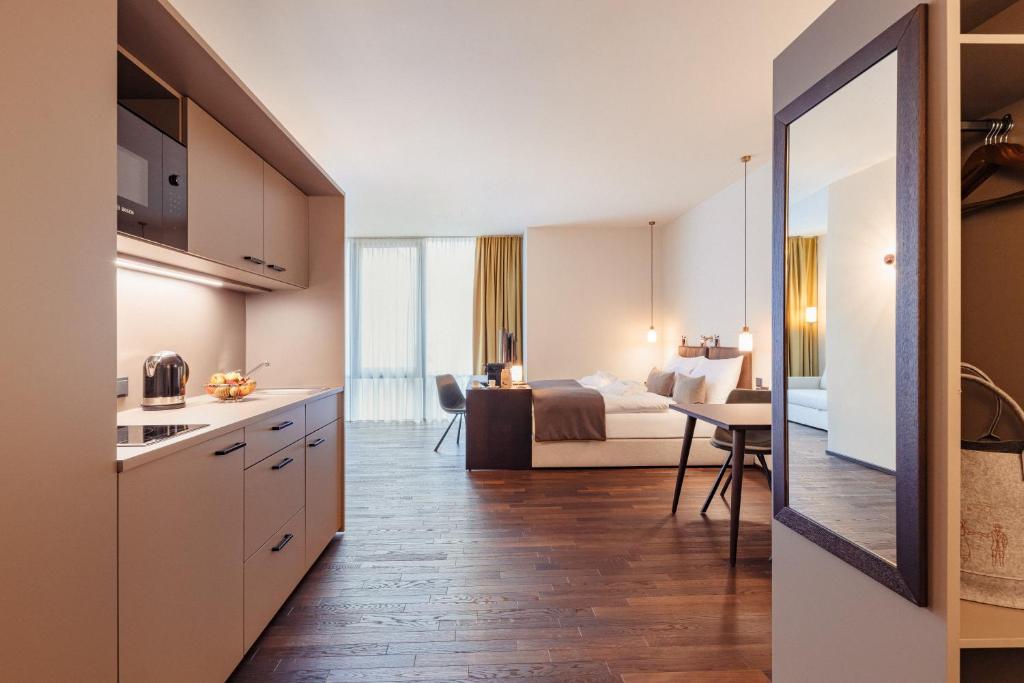 cocina y habitación con cama y mesa en Boutique Hotel das TSCHOFEN Appartements en Bludenz