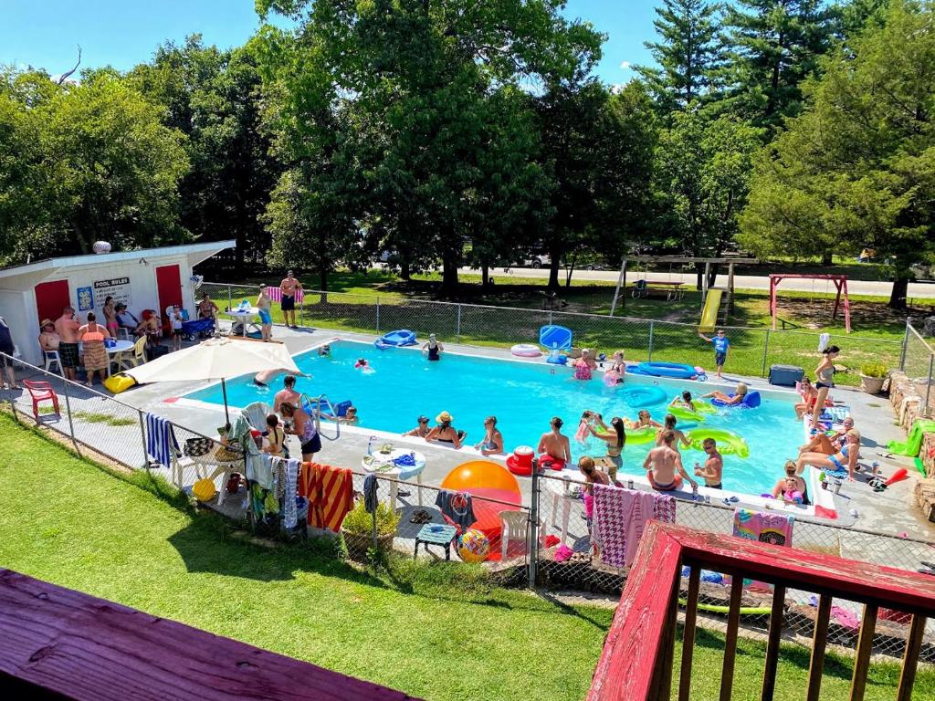 a group of people in a pool at a park at The Cottage Resort in Branson