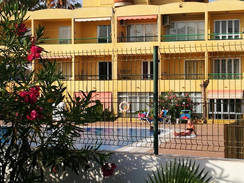 a building with a tennis court in front of it at PLAYA LAS VISTAS LOFT in Los Cristianos
