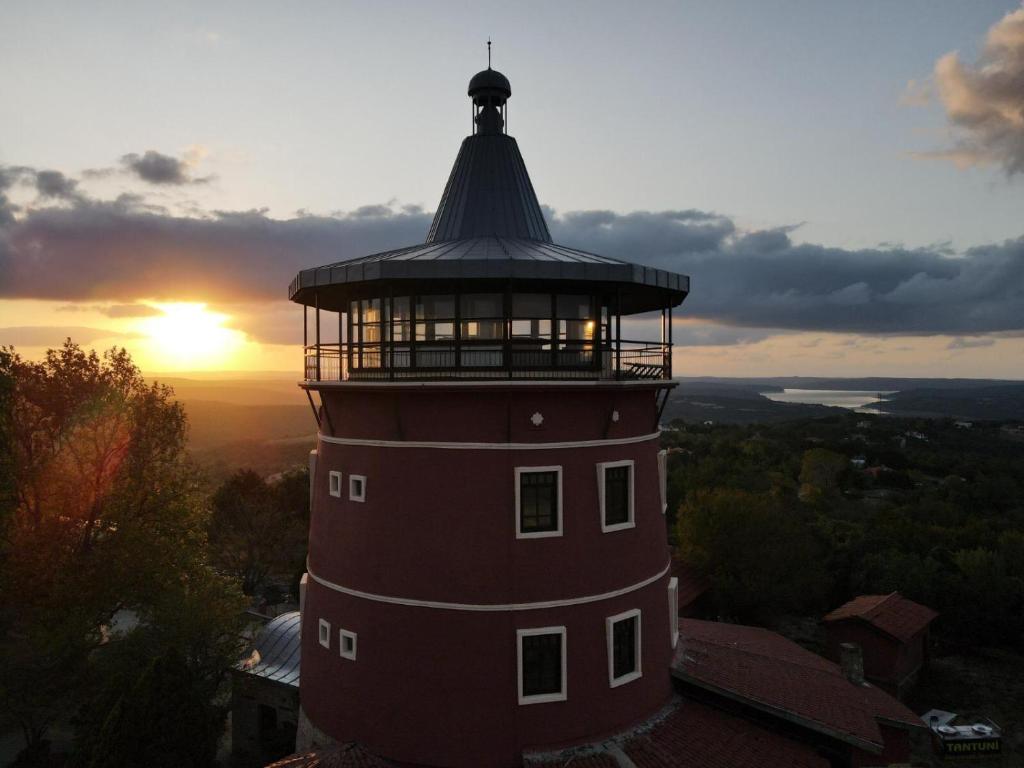 a light house with a tower on top of it at Kule Hotel Airport in Arnavutköy