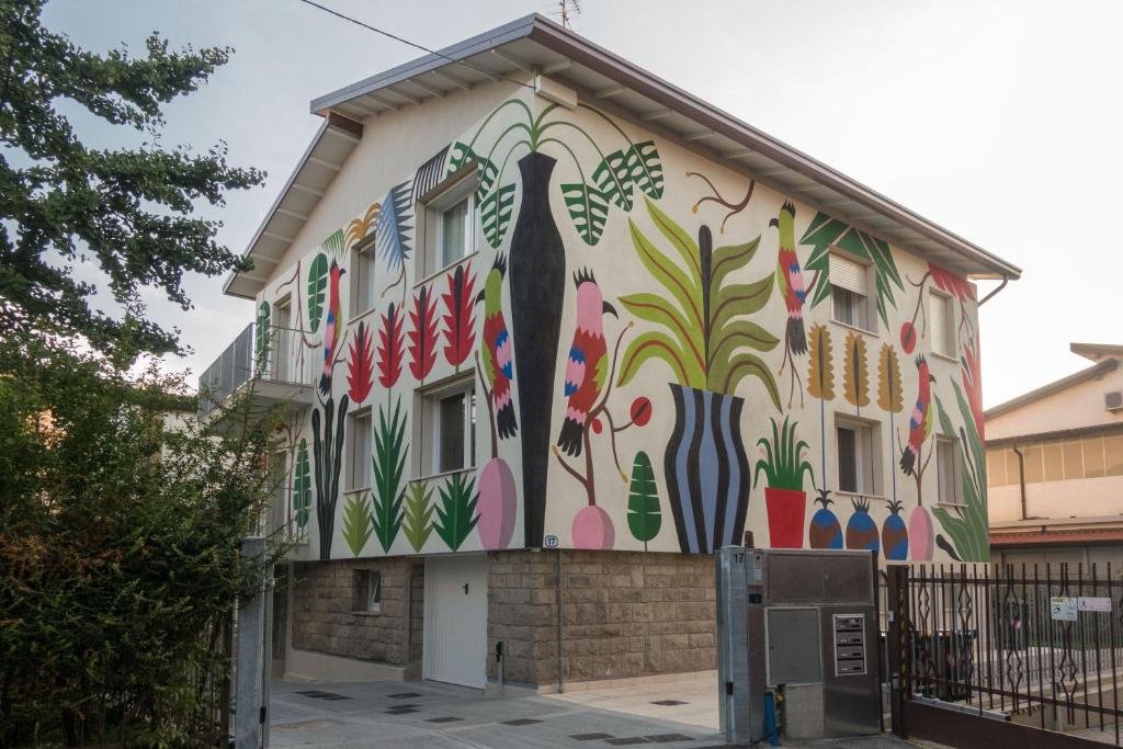 a building with a mural on the side of it at Da Coco - Rooms in Padova