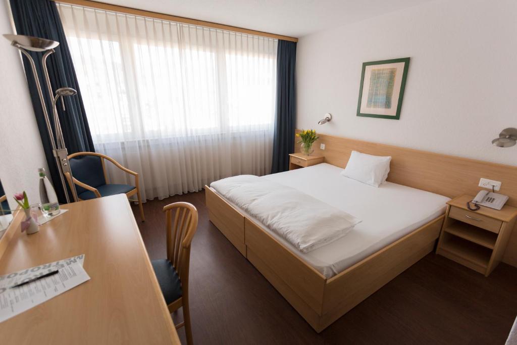 Postel nebo postele na pokoji v ubytování Hotel Metropol