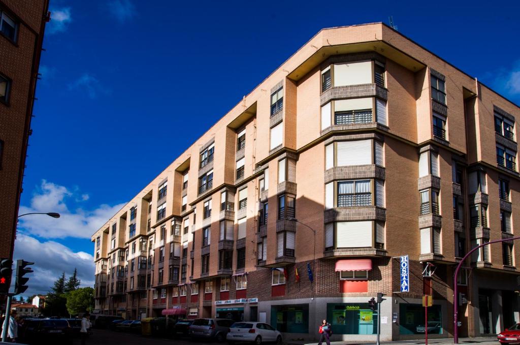 a tall building on a city street with a blue sky at Hostal Algodon in Palencia