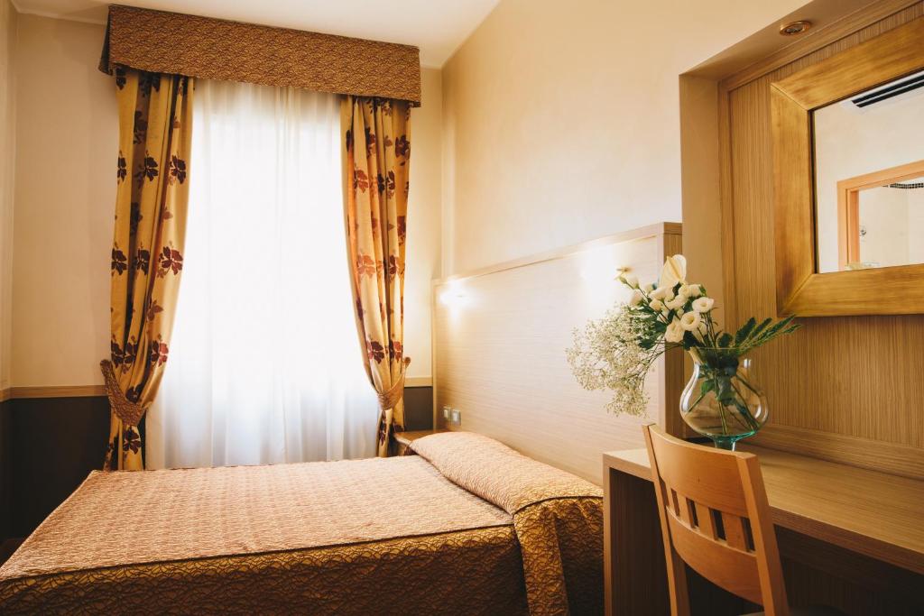 Postel nebo postele na pokoji v ubytování Hotel Corallo
