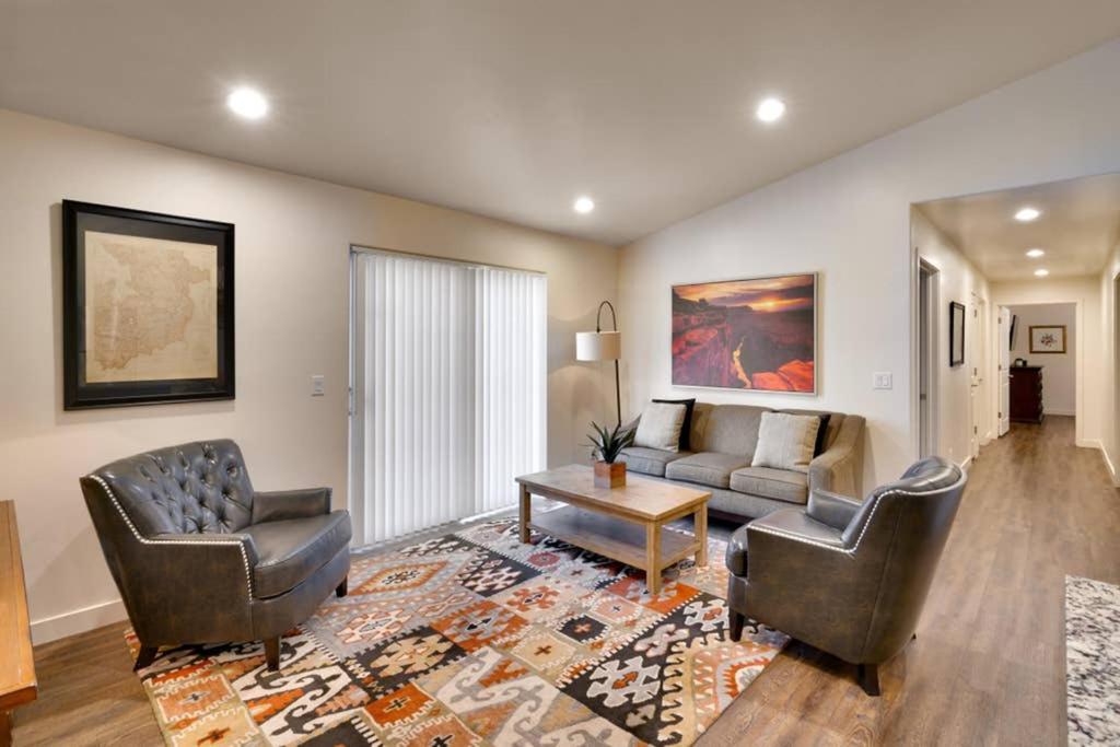 a living room with a couch and two chairs at 5K Top Floor RedCliff Condo, Pool & Hot Tub in Moab