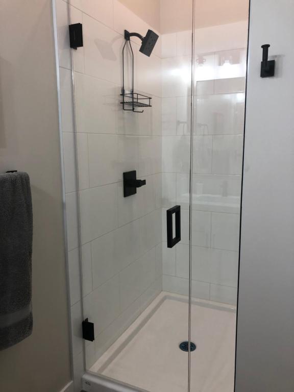 a shower with a glass door in a bathroom at Mountain View Bed & Breakfast in Banff