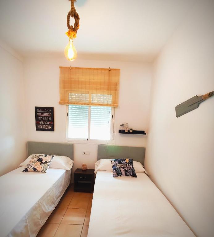 Posteľ alebo postele v izbe v ubytovaní El ático de los flamencos, Apartamentos Living Sur