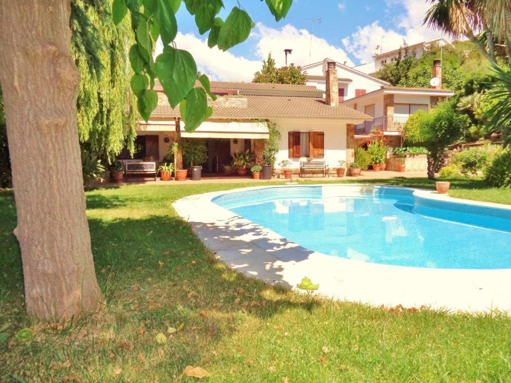 a swimming pool in the yard of a house at Belvilla by OYO Casa Jaume in San Pol de Mar