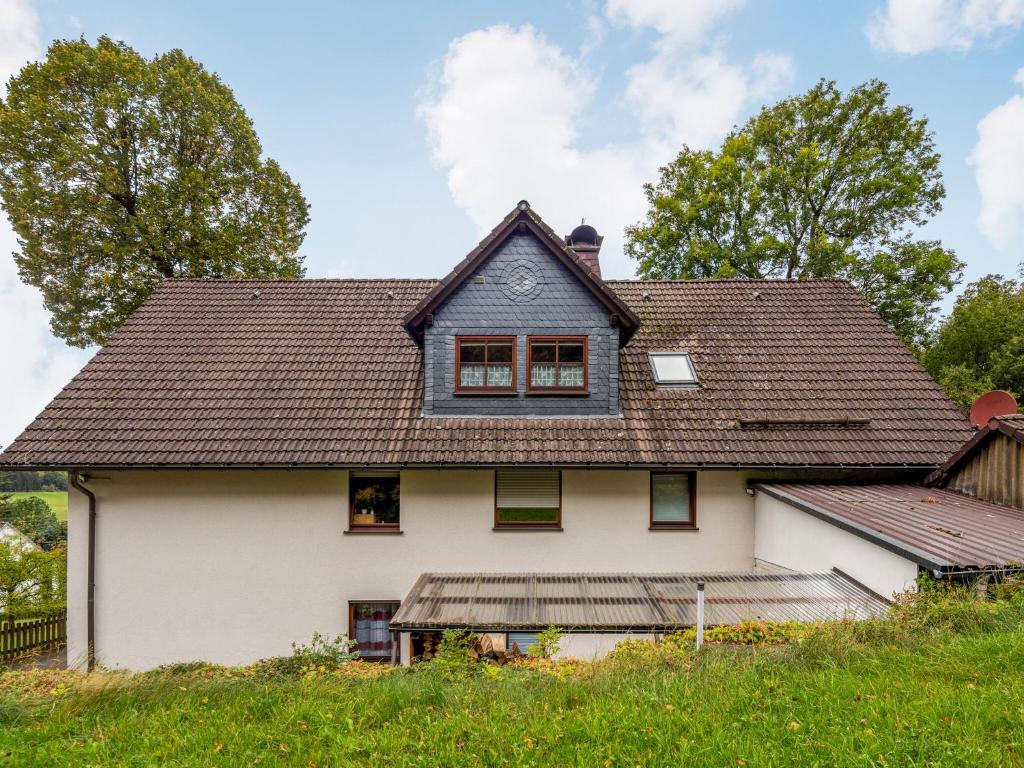 an old white house with a gambrel roof at Vacation home with garden in beautiful Sauerland in Kirchhundem